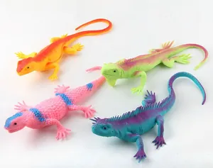 Set of four colorful soft rubber lizard models with realistic scales on white background