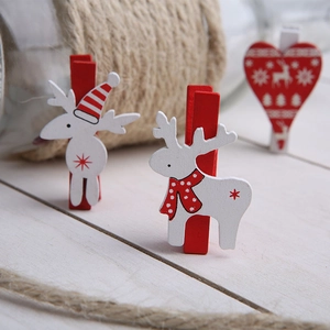 Christmas wooden clips featuring reindeer and heart shapes on a festive table