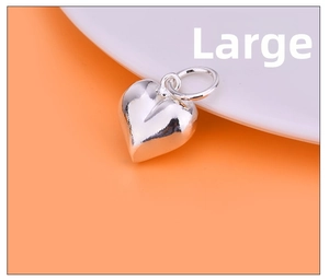 Macro view of large size polished heart charm in S925 sterling silver for DIY jewelry