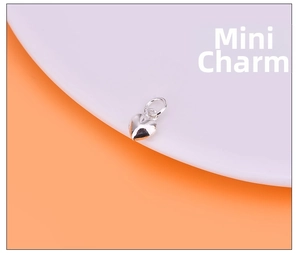 Close-up of mini S925 sterling silver heart charm with polished finish for DIY jewelry