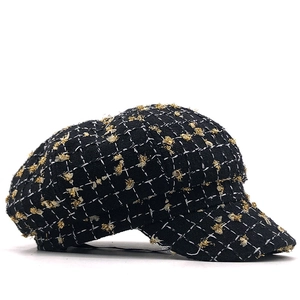 Classic black and white plaid newsboy cap with subtle gold metallic embroidery detail