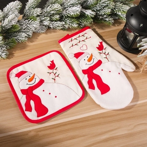 Christmas snowman oven mitt and pot holder set on rustic wood table with holiday decor