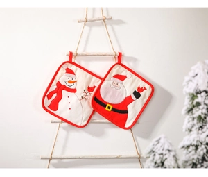 Detail of Christmas oven mitts and pot holders with Santa and Snowman embroidery on wood
