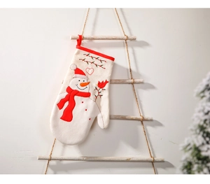 Detail of knitted Christmas oven mitt with snowman embroidery and red hanging loop
