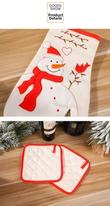 Detail view of snowman embroidery on festive heat resistant oven mitt and coasters