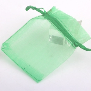 Detail of light green organza gift bag with drawstring closure for jewelry packaging