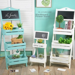 Tiered wooden plant stand with heart decor and chalkboard in blue and white finish