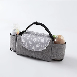 Gray stroller organizer bag with white arrow pattern and bottle holders on white background