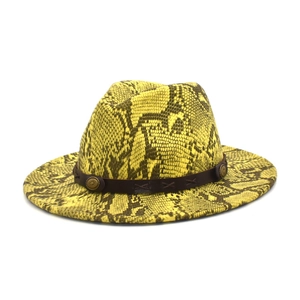 Detail of yellow snakeskin pattern wool fedora with brown leather band and metal studs