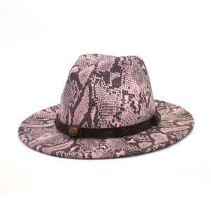 Detail of pink and black snakeskin fedora with brown leather band and metal studs