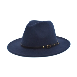 Detail of navy blue wool fedora featuring a black leather band and gold metal buckle