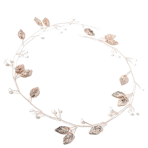 Detail of rose gold bridal hair comb with hand-woven metal leaves and crystal beads