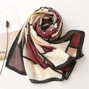 Detailed overhead shot of a geometric pattern cotton linen scarf with elegant wine red accents