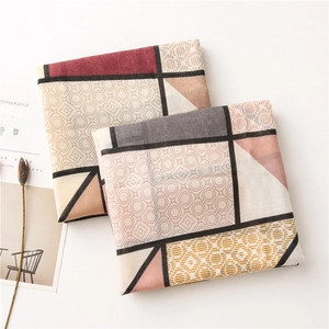 Flat lay of cotton linen scarves with geometric blocks and neutral Morandi tones