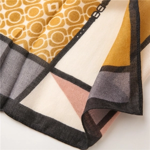 Close-up of geometric pattern scarf with contrast color blocks and fine hemmed edges