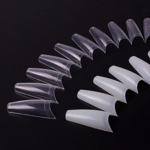 Detailed view of clear and white ballerina coffin nail tips on minimalist black background