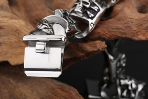 Macro shot of punk skull stainless steel bracelet showing heavy-duty side-press clasp detail