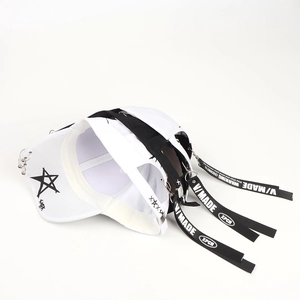Detail of hip hop baseball cap featuring metal ring accents and long star ribbon straps