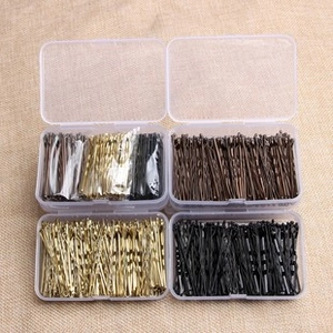 Detail of colorful metal bobby pins in transparent storage boxes on a beige texture background