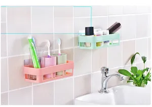 Detail view of pink and green bathroom wall shelves with hollow drainage and toiletries