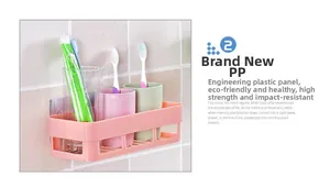 Detail view of pink adhesive bathroom rack showing wall-mounted drainage and storage capacity
