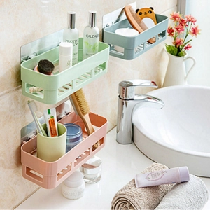 Wall-mounted bathroom shelf organizer in light green, pink, and blue with drainage design