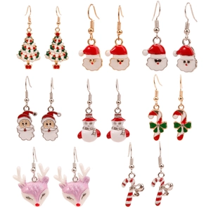 Flat lay of colorful Christmas earrings with Santa Claus, snowmen and reindeer charms