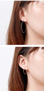 Detail view of gold and silver knot hoop earrings in various sizes on female model