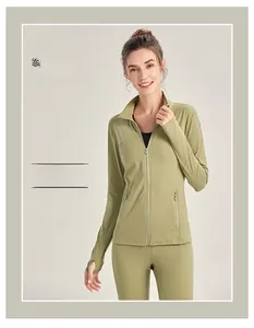 Detail of green sports jacket featuring stand collar and thumbhole cuffs for yoga