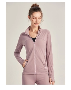 Detail showing high-stretch thumbhole cuffs and side zipper pocket on fitness jacket