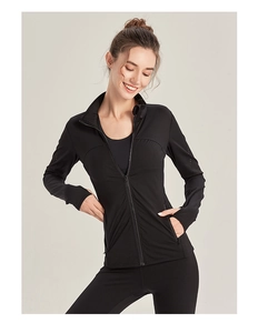 Detail of black slim fit yoga jacket with zipper pockets and functional thumb holes