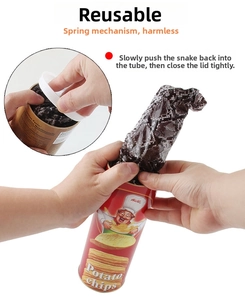 Detailed view of spring snake toy jumping out from a red potato chip canister