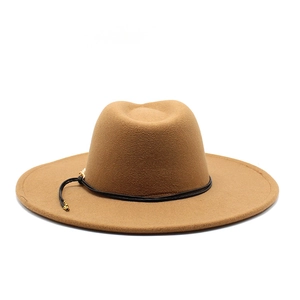Detail of camel wool felt fedora hat featuring black string band and gold buckle