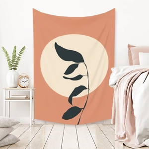 Close-up of bohemian Morandi tapestry featuring orange sun and black leaf silhouettes