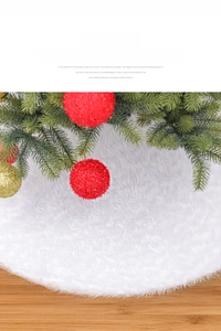 Detail of plush white faux fur Christmas tree skirt on wooden floor for holiday decor