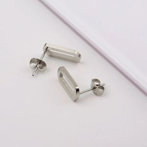 Minimalist silver stainless steel hollow rectangular stud earrings on white background