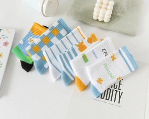 Detail view of 6-pair cotton sock set featuring colorful patterns and ribbed cuffs
