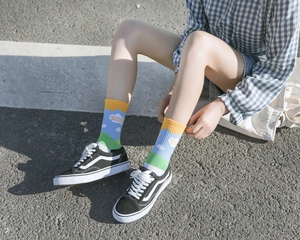 Close-up of Japanese style cotton crew socks with clouds and green grass pattern