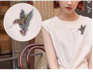Macro detail of rhinestone hummingbird brooch and a model wearing it on a white shirt