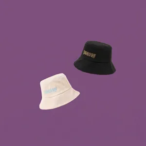Minimalist black and beige cotton bucket hats with peacey embroidery on purple background