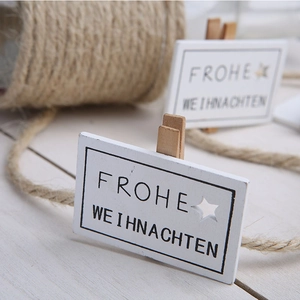 Decorative wooden Christmas clips with Frohe Weihnachten text and star cutout for photos