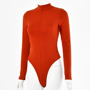 Detail of orange-red ribbed bodysuit with front zipper closure on white mannequin