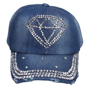 Close-up of sparkling rhinestone crown pattern and distressed details on denim baseball cap