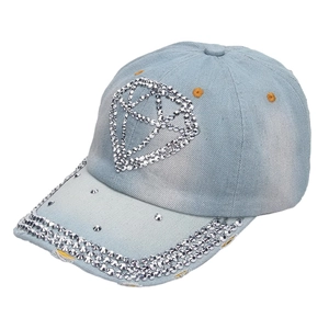 Detail of blue denim baseball cap featuring diamond rhinestone pattern and metal studs