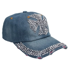 Detail of blue denim baseball cap with rhinestone cross and distressed brim edges