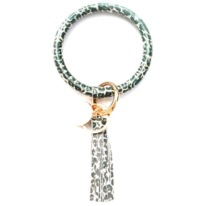 Detail of leopard print PU leather wristlet keychain with gold clasp and tassel charm
