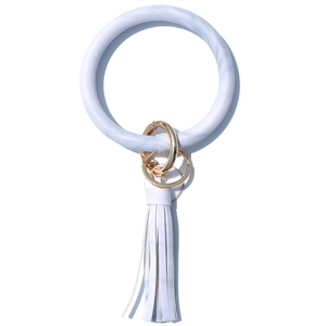Close-up of marble pattern PU leather wristlet keychain with blue tassel and gold ring