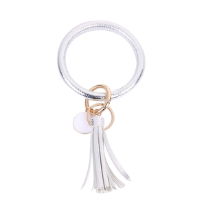 Detail view of silver PU leather ring keychain with gold clasp and matching tassel