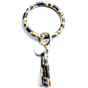 Detail of sunflower print PU leather wristlet keychain with golden tassel and lobster clasp