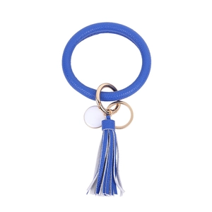 Macro shot of royal blue PU leather keychain ring with matching tassel and gold hardware